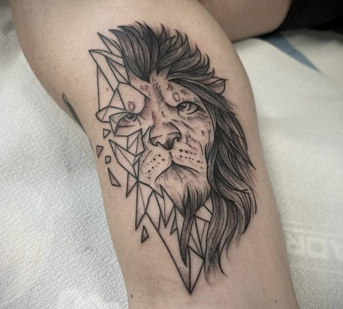 Geometric lion face arm tattoo