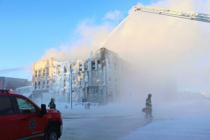 Firefighters Working To Extinguish A Blaze Today In Alberta, Canada In Freezing Temps