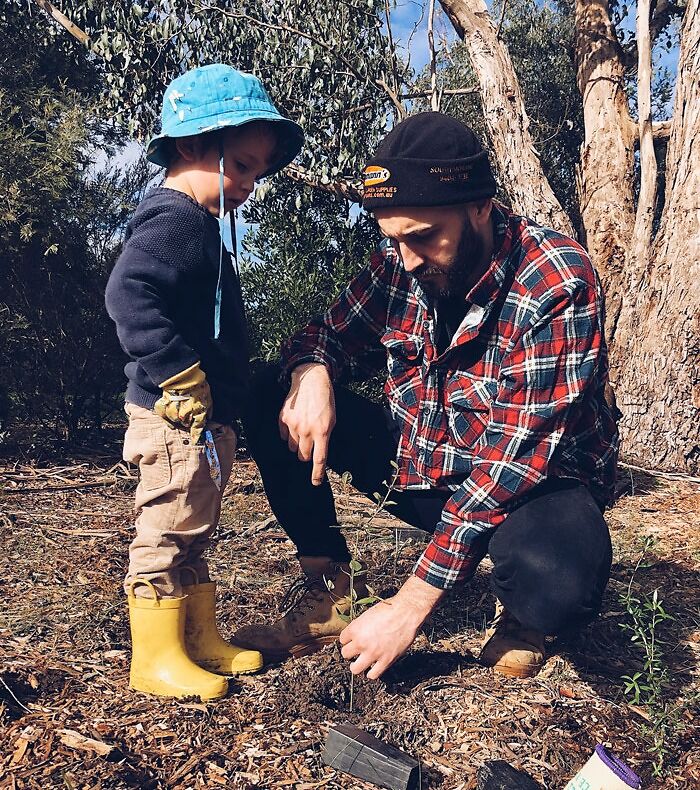Father and son planting a tree 