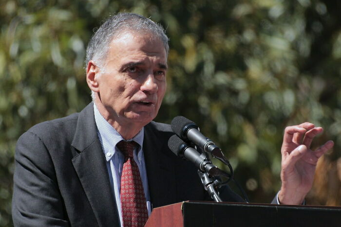 Ralph Nader speaking at a podium, wearing a tie and suit, featured among celebrities who never married but found love.