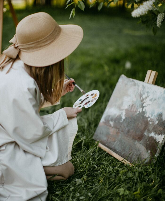 Woman Painting Canvas In Park 