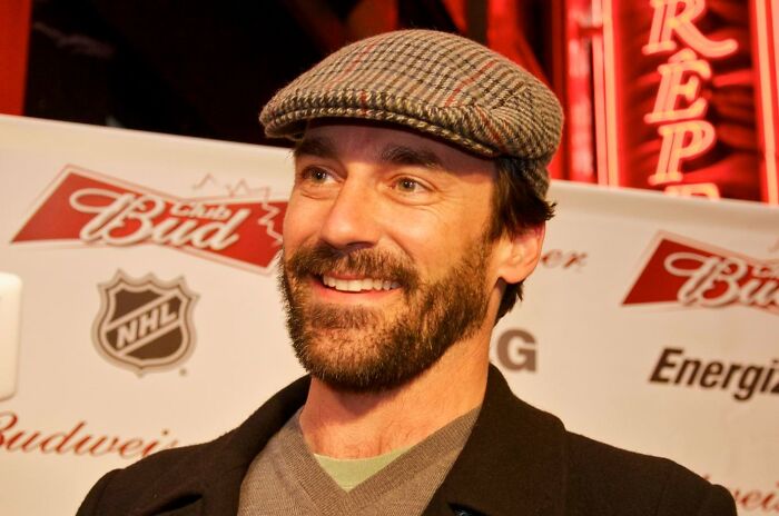 Jon Hamm wearing a patterned hat and dark coat, representing celebrities who never married yet still found love.