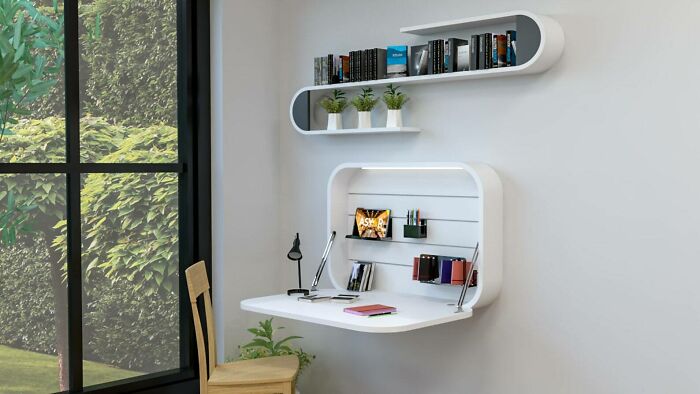 Home organization idea: minimalist wall-mounted desk with shelves and decor items in a bright room.