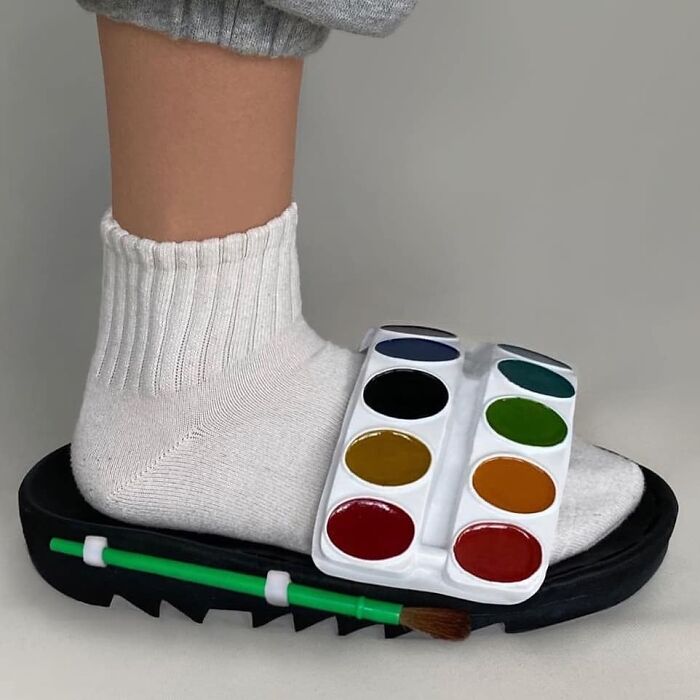 A shoe designed with a colorful paint palette and brush for a quirky look.