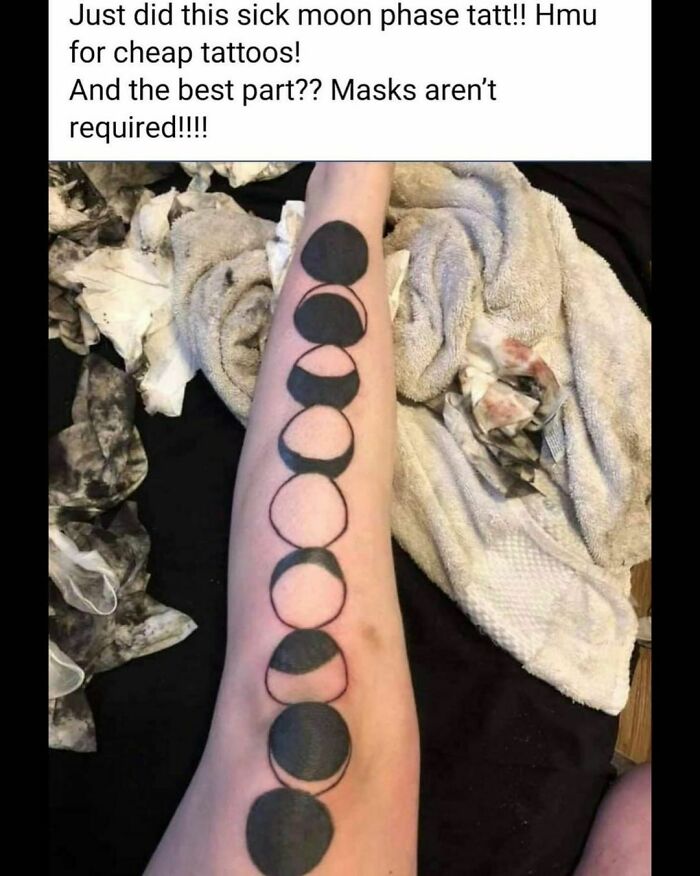 Arm with a poorly executed moon phase tattoo, surrounded by messy towels and staining.