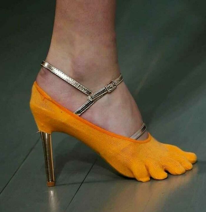 Weird shoes with orange toe socks and gold straps, high-heeled design.