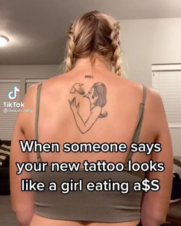 Person with a tattoo on their back, featuring an unintended design, highlighting poorly thought-through tattoo choices.