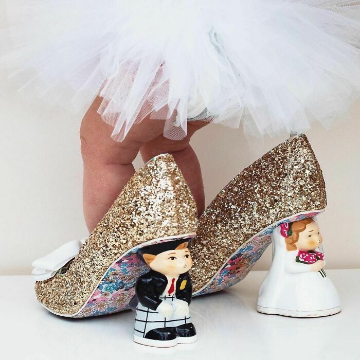 Weird shoes featuring glittery heels and figurines of a groom and bride.
