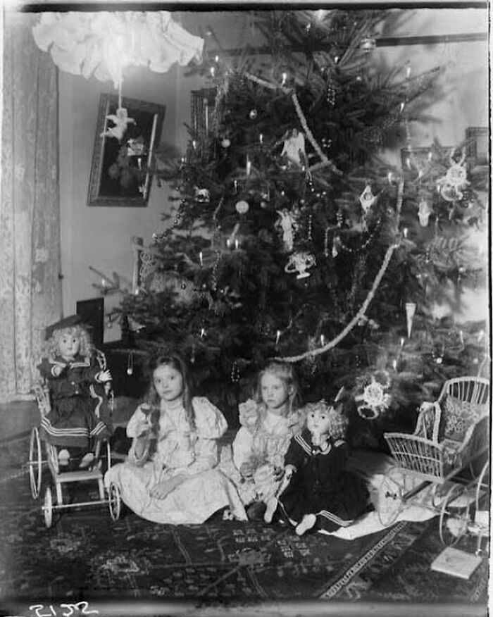 Two Girls Under A Christmas Tree With Their Dolls, On Christmas Day Circa 1899