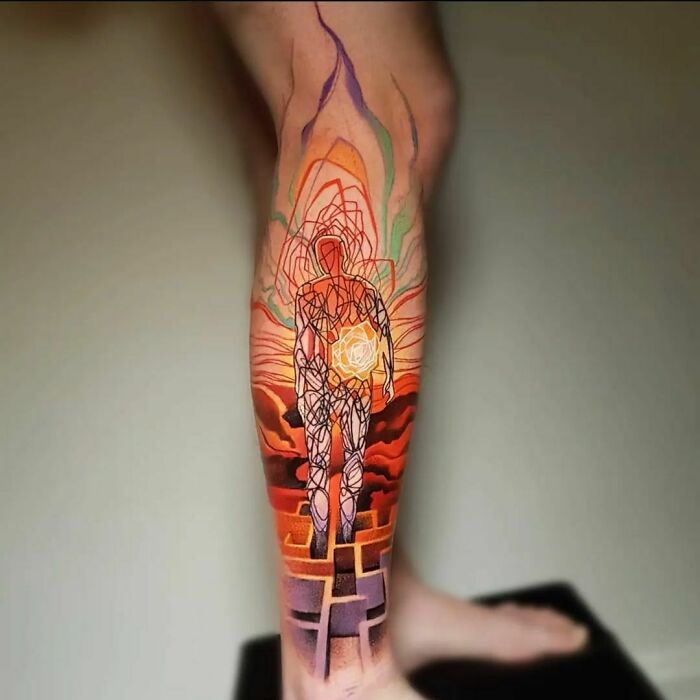 Colorful geometric tattoo of a person on a leg, featuring intricate patterns and vibrant hues.