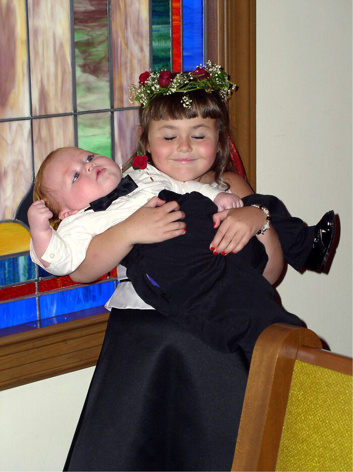 A Picture Of Five Year Old Me Holding My Brother At My Cousin's Wedding 