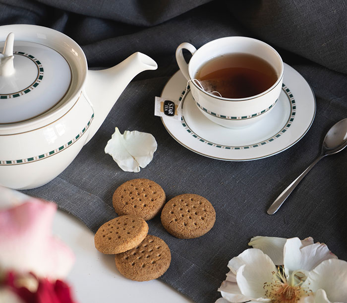 Cookies and a tea in white tea set 