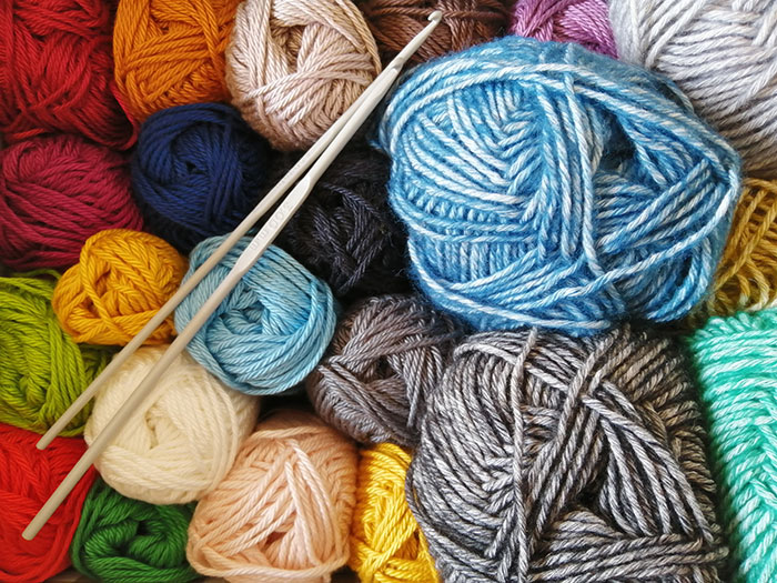 Multiple colorful Knitting threads and needles 
