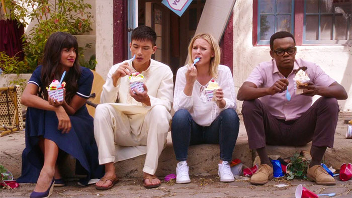 The Good Place characters sitting and eating cakes