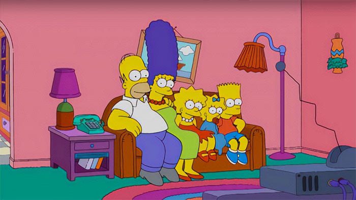 The Simpsons family sitting on a sofa