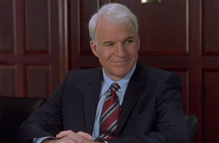 Steve Martin wearing suit and smiling in movie Bringing Down The House