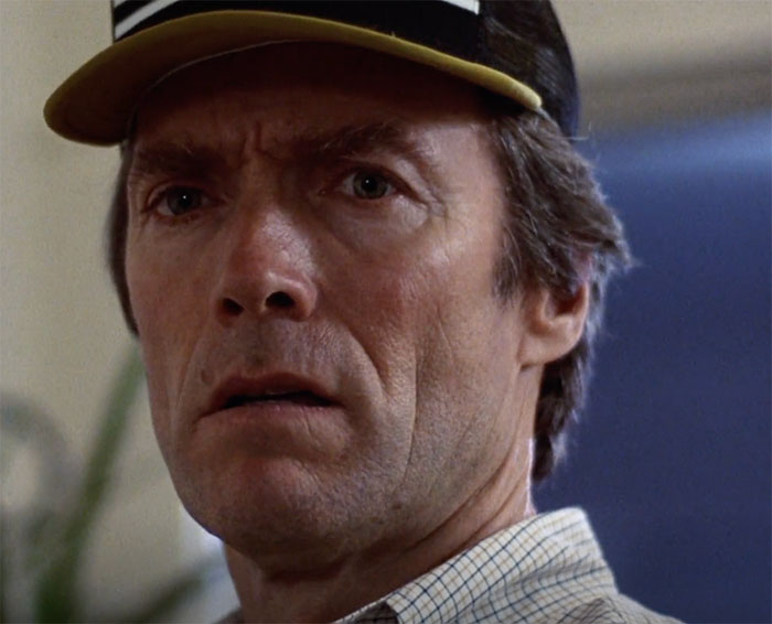Clint Eastwood wearing hat and looking in movie Tightrope