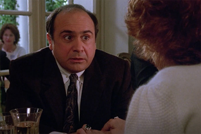 Danny DeVito wearing suit and looking in movie Ruthless People