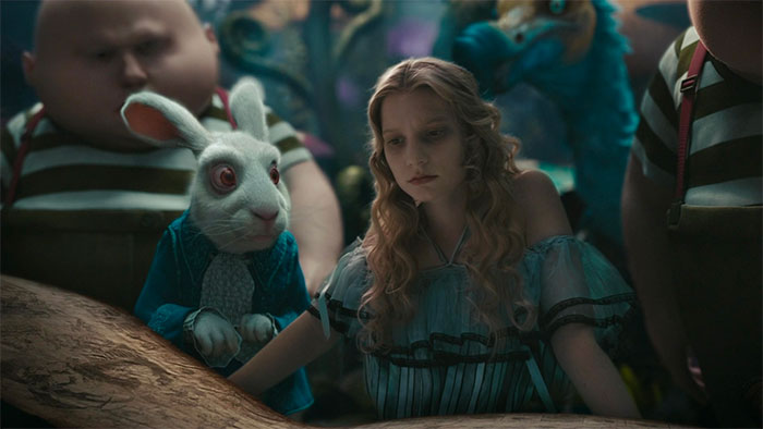 Mia Wasikowska with rabbit in movie Alice In Wonderland