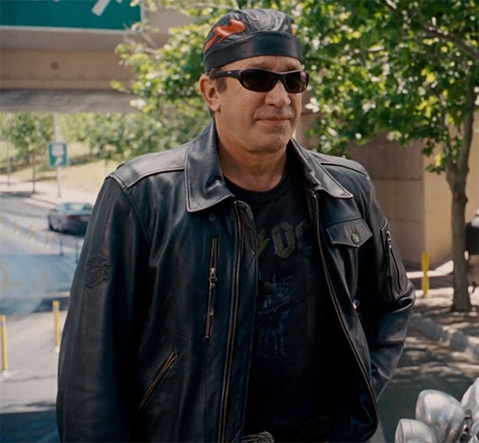 John Travolta wearing leather jacket and glasses in movie Wild Hogs