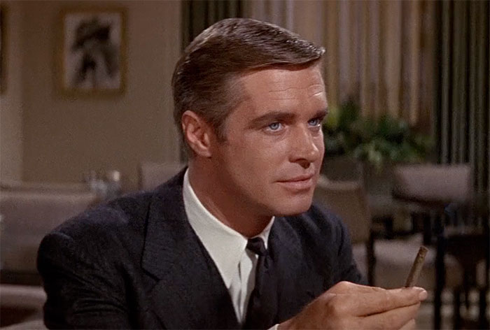 George Peppard wearing suit in movie The Carpetbaggers