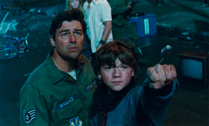 Kyle Chandler and Joel in movie standing and looking in movie Super 8