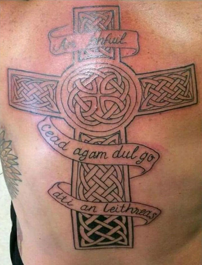 Cross with words on it back tattoo 