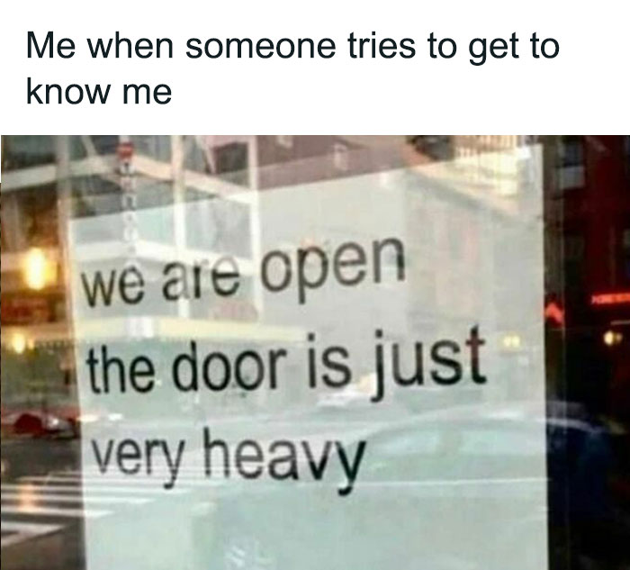 Therapist meme: A sign reads "we are open the door is just very heavy," humorously describing emotional barriers.