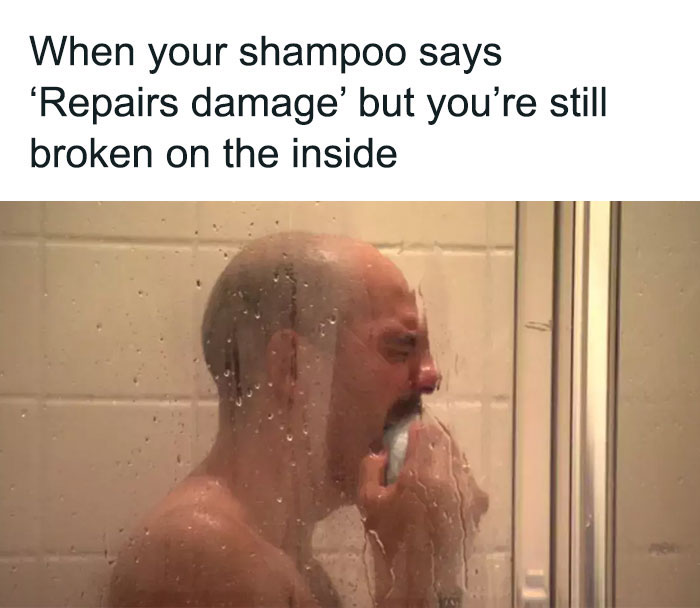 Man crying in the shower holding shampoo, expressing irony about emotional repair.