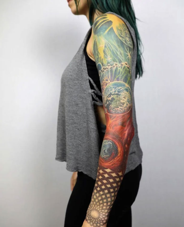 Cosmic and geometric left arm sleeve tattoo