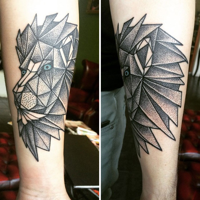 Geometric tattoo of a lion with intricate dot patterns on the forearm.