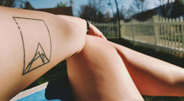 Simple geometric mountain tattoo on arm