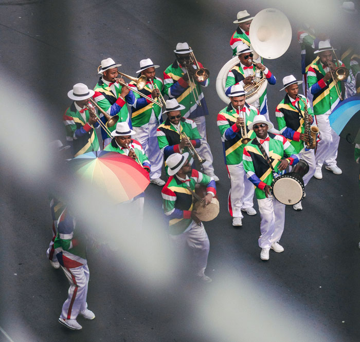 An orchestra of people dressed in South African flag colors on a street in South Africa