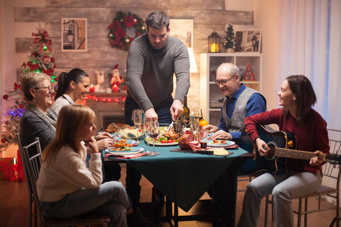 A family eating festive dinner and celebrating Christmas 