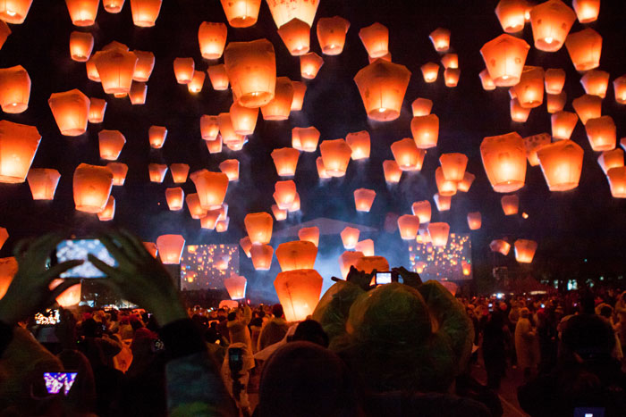 Many lighted lanterns in the sky at Pingxi Sky Lantern Festival 2014 in Taiwan