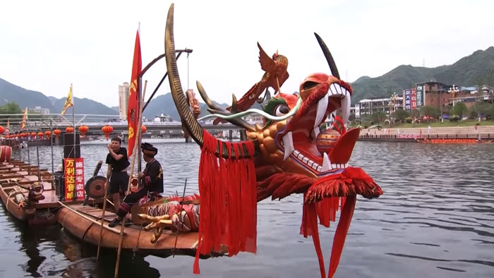 Red dragon boat in the water at Dragon Boat Festival in China