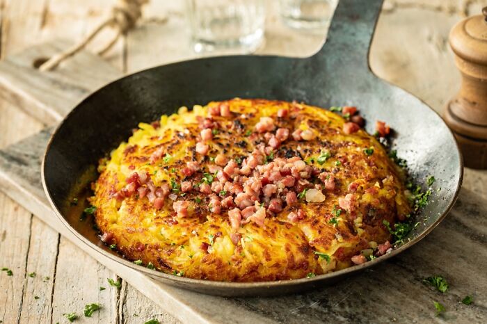 Rösti, Dish From Switzerland. Graded Potatoes With Bacon And Sometimes An Egg On Top