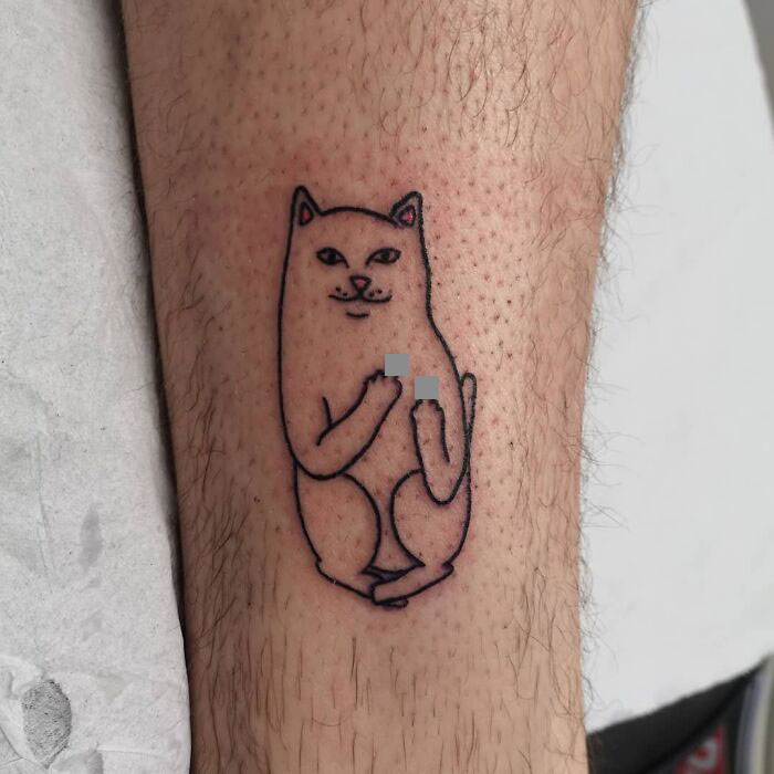 Funny cat tattoo depicting a playful feline with an amusing expression on a person's leg.