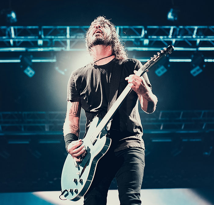 Person playing with guitat at the concert