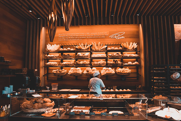 Person standing at bakery shop