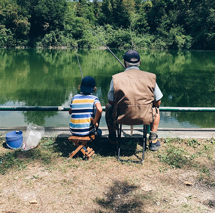 Grandfather and kid fishing