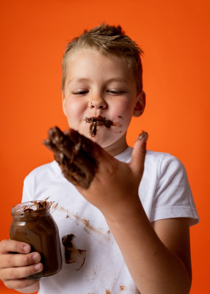 Boy Eating Chocolate Straight From His Fingers 