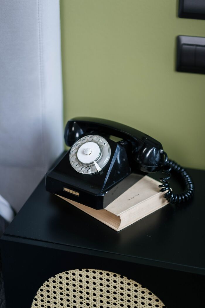Black Landline Phone On A Book 