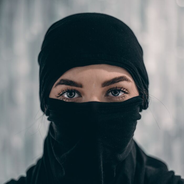 Woman With Her Face Covered And Blue Eyes 