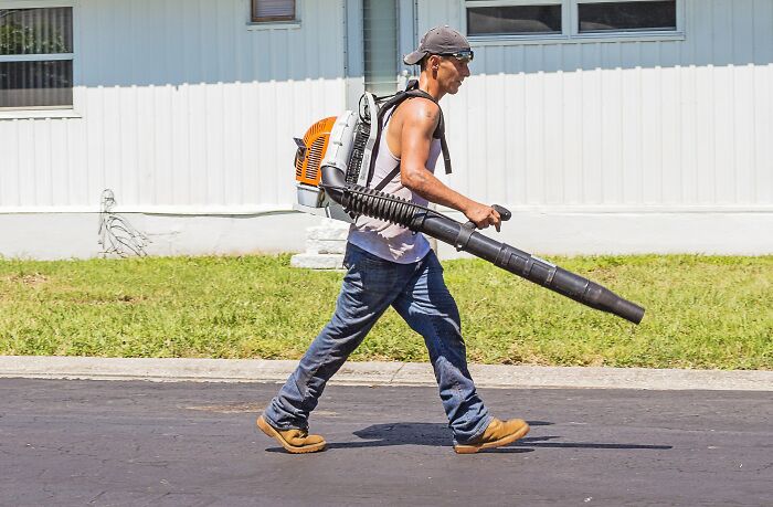 Person walking with leaf blower