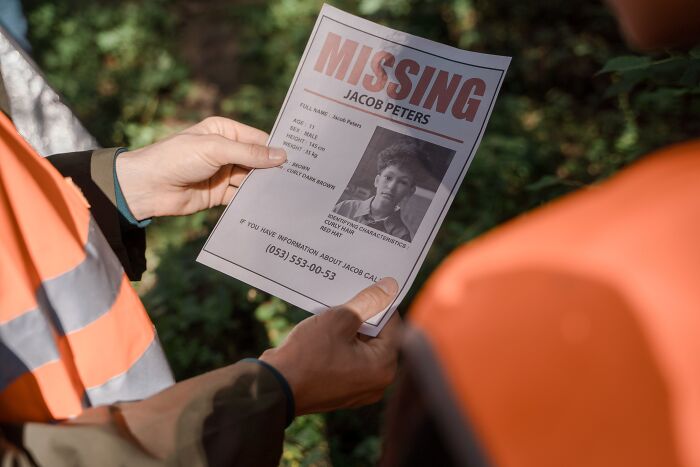 Person Holding Missing Person Poster In Hands 