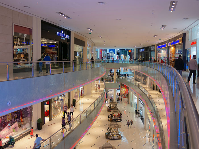 Shopping mall with shops and people walking