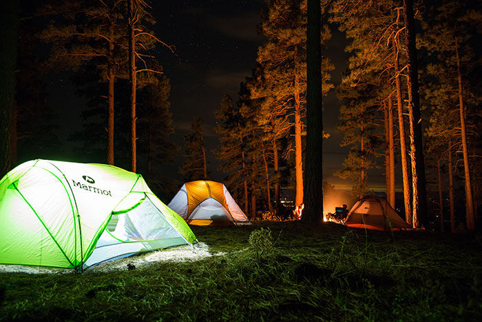 Tents with lights and person camping