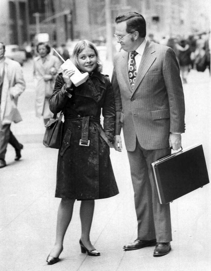 Jeanne Bauer Walks With A Dynatac Mobile Phone On 6th Avenue In New York, Accompanied By John Mitchell, The Motorola Engineer Behind The Phone. (1983)
