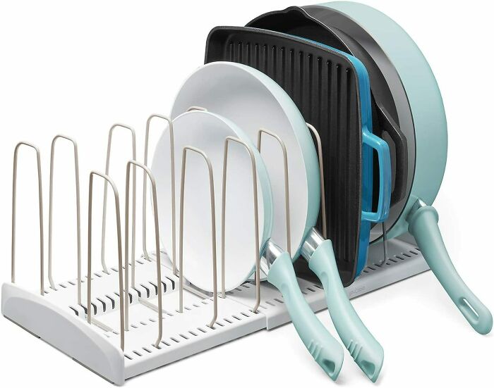 Pot and pan organizer holding kitchenware for efficient home organization.